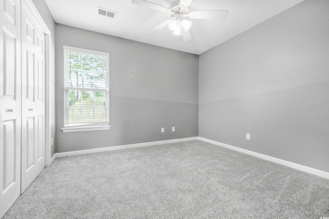 spare room featuring carpet floors and ceiling fan