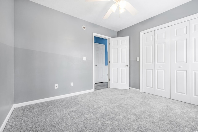 unfurnished bedroom featuring ceiling fan, a closet, and carpet