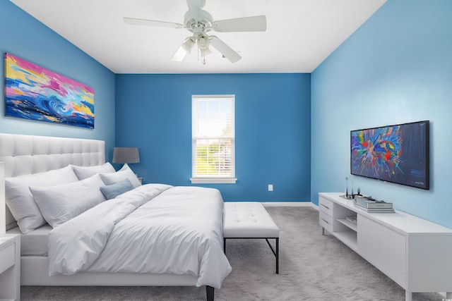 bedroom featuring light colored carpet and ceiling fan