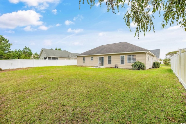 back of property featuring a lawn