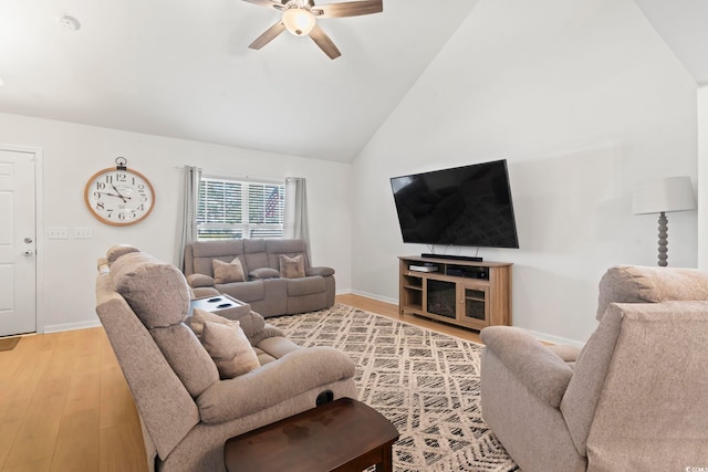 living room featuring high vaulted ceiling, light hardwood / wood-style floors, and ceiling fan