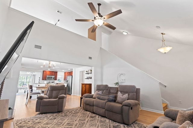 living room featuring ceiling fan and light wood-type flooring