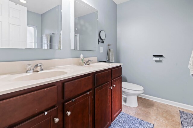 bathroom featuring vanity, tile patterned floors, and toilet