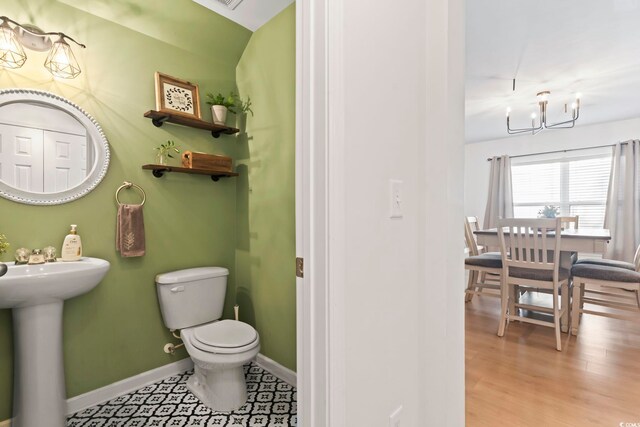 bathroom with sink, hardwood / wood-style floors, and toilet