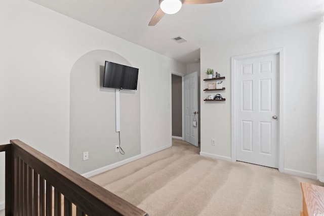 carpeted spare room with ceiling fan