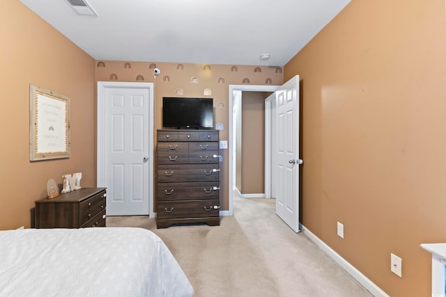 bedroom with light colored carpet