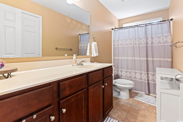 full bathroom with vanity, tile patterned floors, shower / bath combination with curtain, and toilet