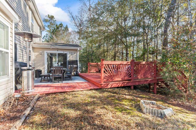 view of yard featuring a wooden deck and an outdoor fire pit