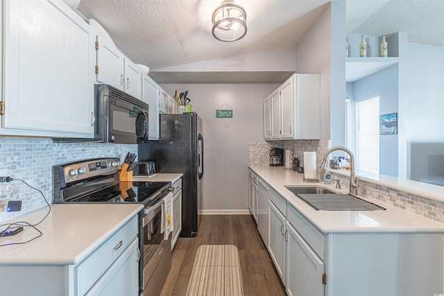 kitchen with lofted ceiling, dark wood-style floors, stainless steel electric range oven, black microwave, and a sink