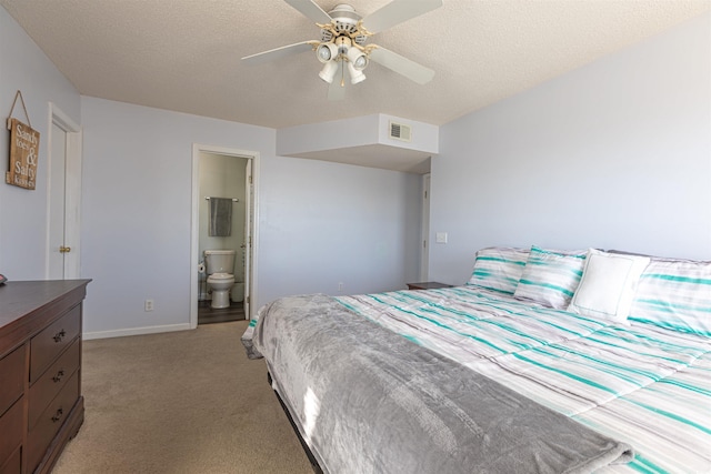 bedroom featuring a textured ceiling, ceiling fan, ensuite bathroom, light colored carpet, and visible vents