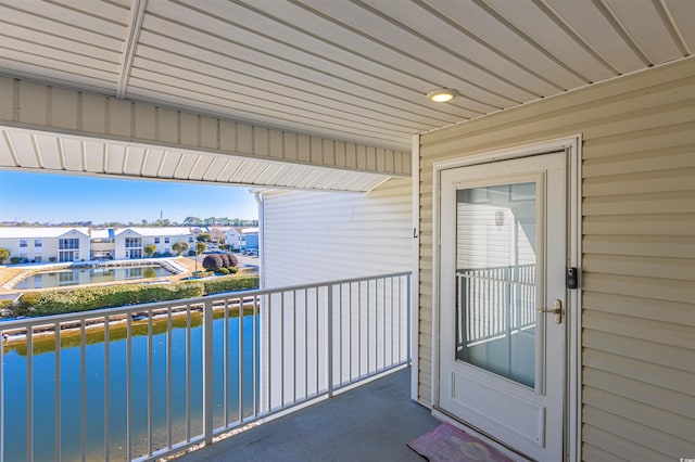 balcony featuring a water view and a residential view