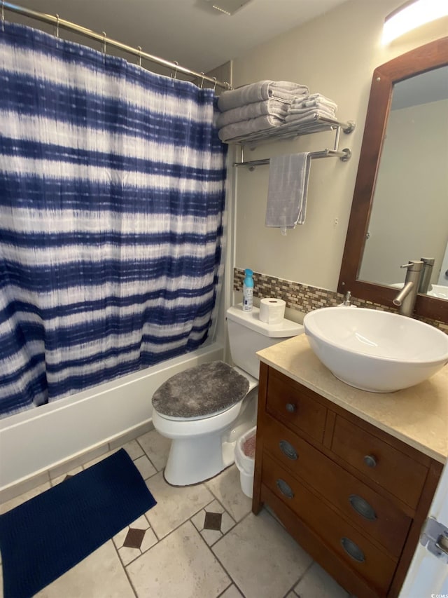 full bathroom featuring shower / tub combo with curtain, tile patterned floors, toilet, tasteful backsplash, and vanity