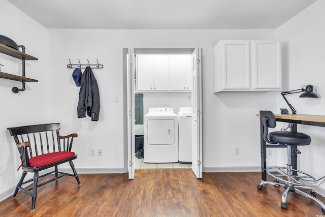 laundry room featuring cabinets, dark hardwood / wood-style floors, and independent washer and dryer