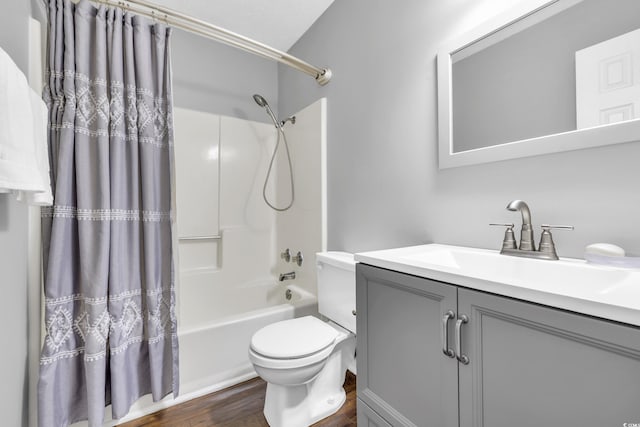 full bathroom featuring vanity, toilet, hardwood / wood-style floors, and shower / bath combo