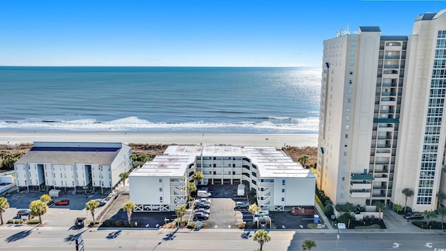 aerial view with a water view and a beach view