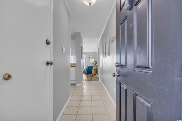 corridor with ornamental molding and light tile patterned floors