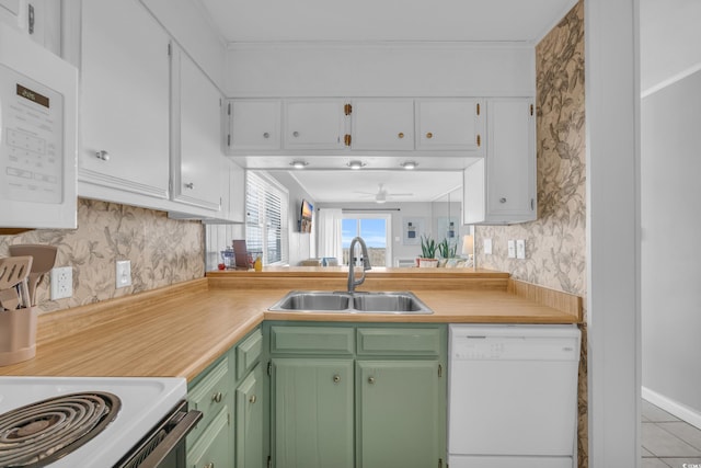 kitchen with sink, white cabinets, ceiling fan, green cabinetry, and white appliances