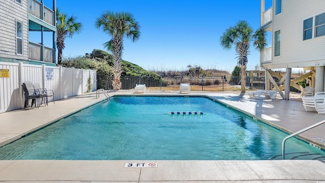 view of swimming pool with a patio