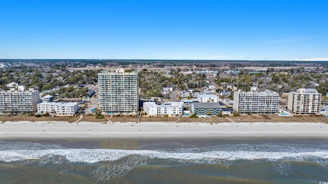 bird's eye view featuring a water view and a beach view