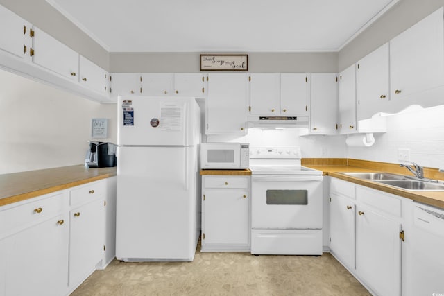 kitchen featuring white appliances, sink, and white cabinets