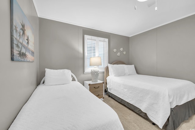 carpeted bedroom with crown molding and ceiling fan