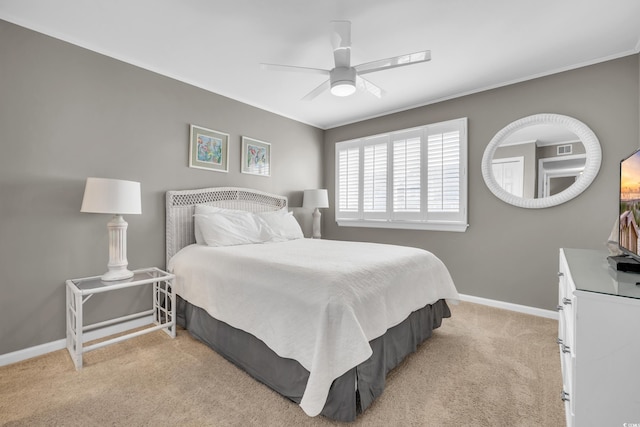 carpeted bedroom featuring crown molding and ceiling fan