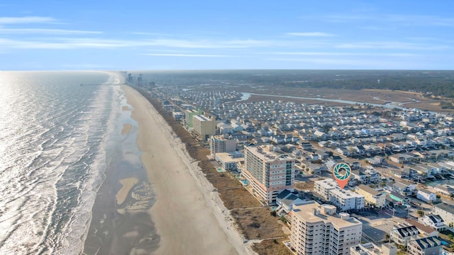 birds eye view of property with a water view and a beach view