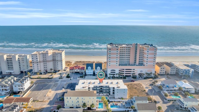 drone / aerial view with a beach view and a water view