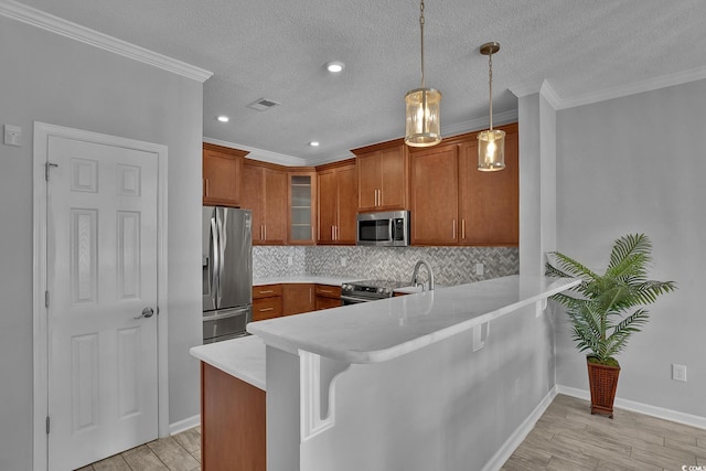 4200 Coquina Harbour Dr Unit H3, Little River, SC 29566 - kitchen with appliances with stainless steel finishes, a peninsula, brown cabinets, glass insert cabinets, and a textured ceiling