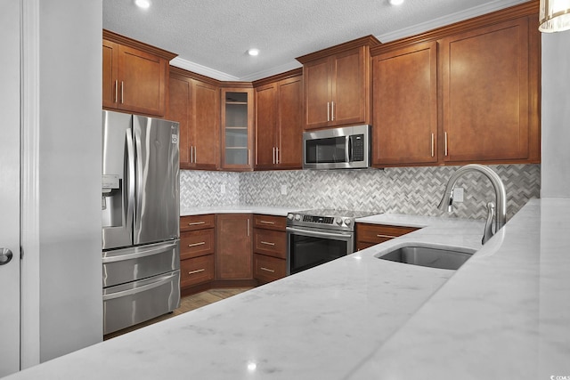 4200 Coquina Harbour Dr Unit H3, Little River, SC 29566 - kitchen featuring appliances with stainless steel finishes, light stone counters, glass insert cabinets, a textured ceiling, and backsplash
