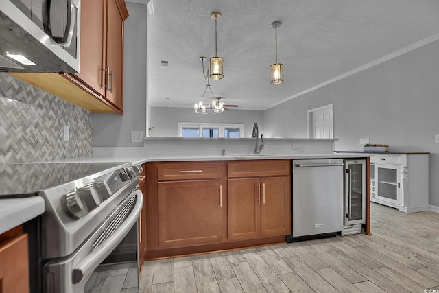 4200 Coquina Harbour Dr Unit H3, Little River, SC 29566 - kitchen with appliances with stainless steel finishes, beverage cooler, brown cabinetry, wood finish floors, and decorative backsplash