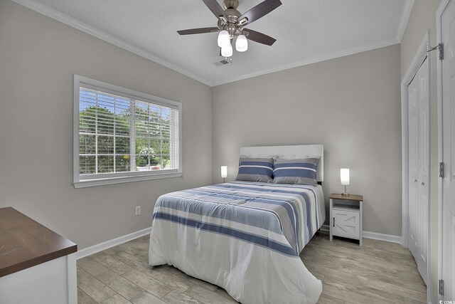 4200 Coquina Harbour Dr Unit H3, Little River, SC 29566 - bedroom with light wood-type flooring, crown molding, ceiling fan, and a closet