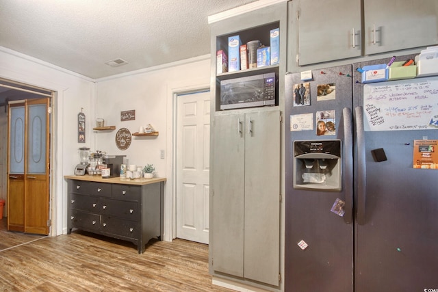 interior space with a textured ceiling and light hardwood / wood-style flooring