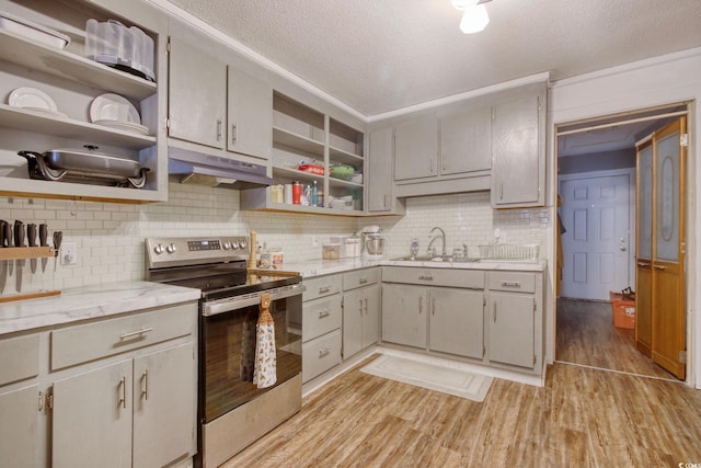 kitchen featuring sink, tasteful backsplash, light hardwood / wood-style flooring, a textured ceiling, and electric stove