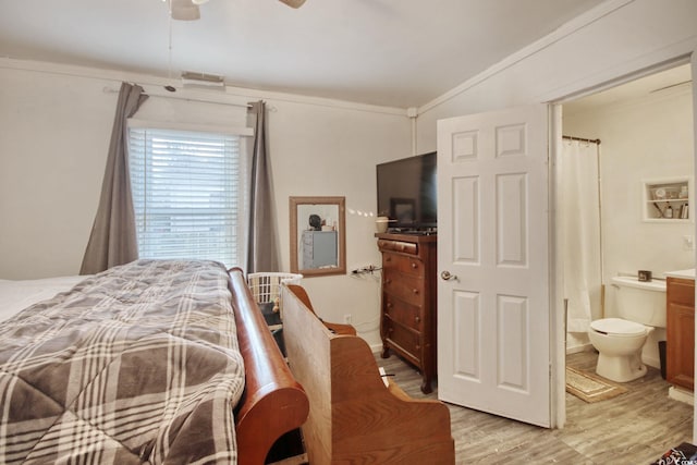 bedroom featuring crown molding, ensuite bathroom, ceiling fan, and light hardwood / wood-style floors