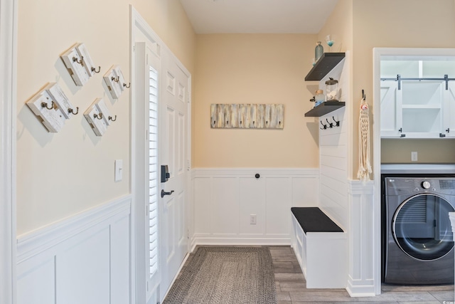 4609 Lightkeepers Way Unit 11J, Little River, SC 29566 - laundry area with cabinet space, a wainscoted wall, a decorative wall, washer / clothes dryer, and wood finished floors