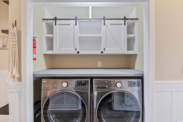 4609 Lightkeepers Way Unit 11J, Little River, SC 29566 - washroom with wainscoting, cabinet space, separate washer and dryer, and a decorative wall