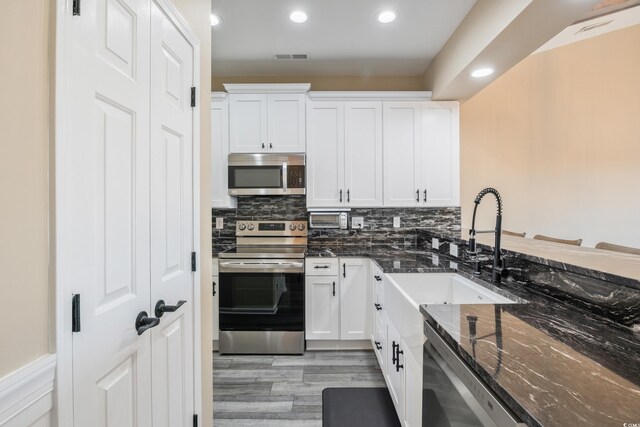 4609 Lightkeepers Way Unit 11J, Little River, SC 29566 - kitchen with recessed lighting, a sink, appliances with stainless steel finishes, and white cabinetry