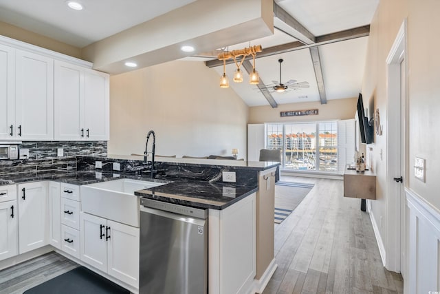 4609 Lightkeepers Way Unit 11J, Little River, SC 29566 - kitchen with stainless steel dishwasher, a sink, a peninsula, a ceiling fan, and vaulted ceiling with beams