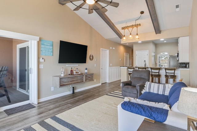 4609 Lightkeepers Way Unit 11J, Little River, SC 29566 - living area with wood finished floors, beamed ceiling, ceiling fan, visible vents, and a towering ceiling