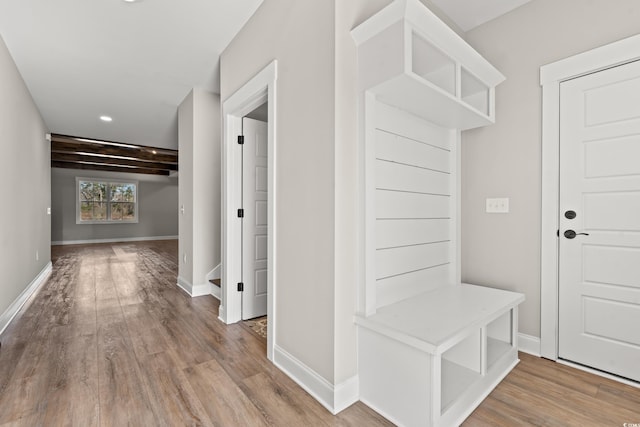 mudroom featuring wood finished floors and baseboards