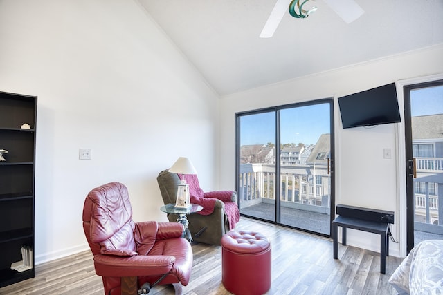 living area featuring lofted ceiling and hardwood / wood-style flooring