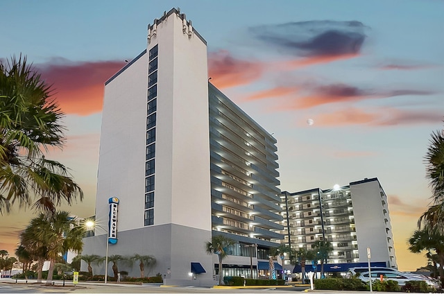 view of outdoor building at dusk