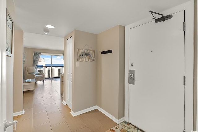 hallway featuring light tile patterned floors