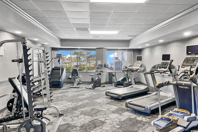 exercise room with crown molding and a drop ceiling