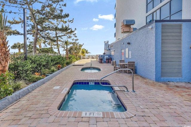 view of pool featuring a patio area and a hot tub