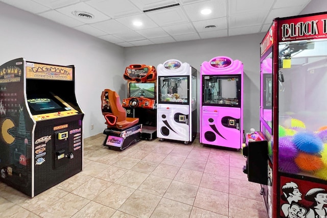 game room with a paneled ceiling and tile patterned floors