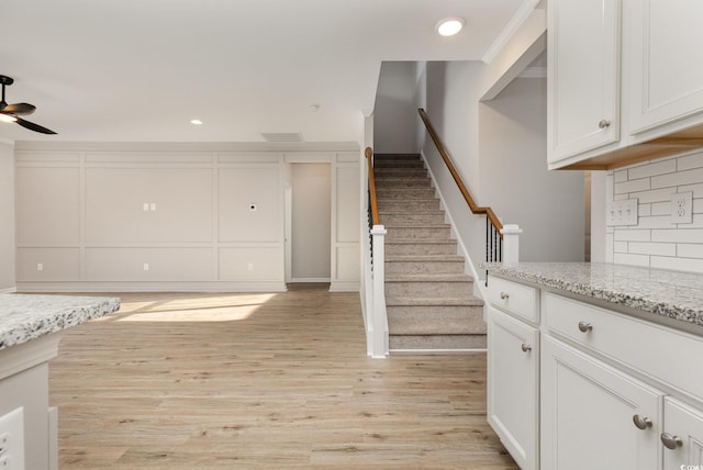 interior space featuring hardwood / wood-style floors, ornamental molding, and ceiling fan