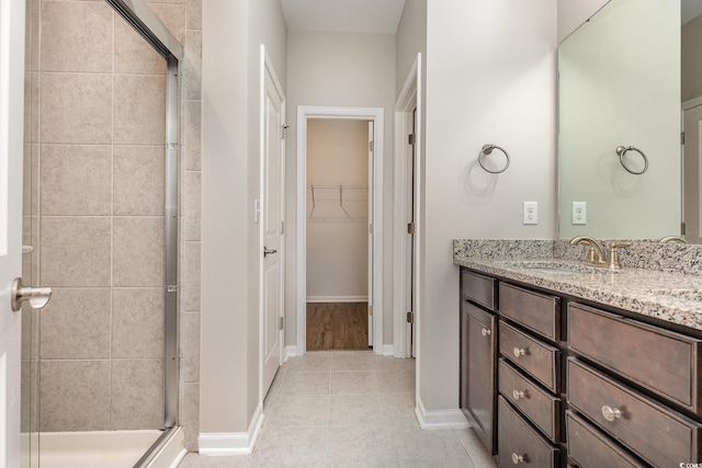 bathroom with vanity, tile patterned floors, and walk in shower