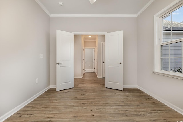 unfurnished bedroom with ornamental molding and light hardwood / wood-style floors